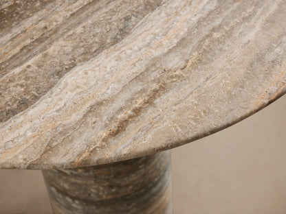 Perth Stone Bistro Table with a round top and a tapered cylindrical base, displaying natural stone patterns in earthy brown, beige, and grey.