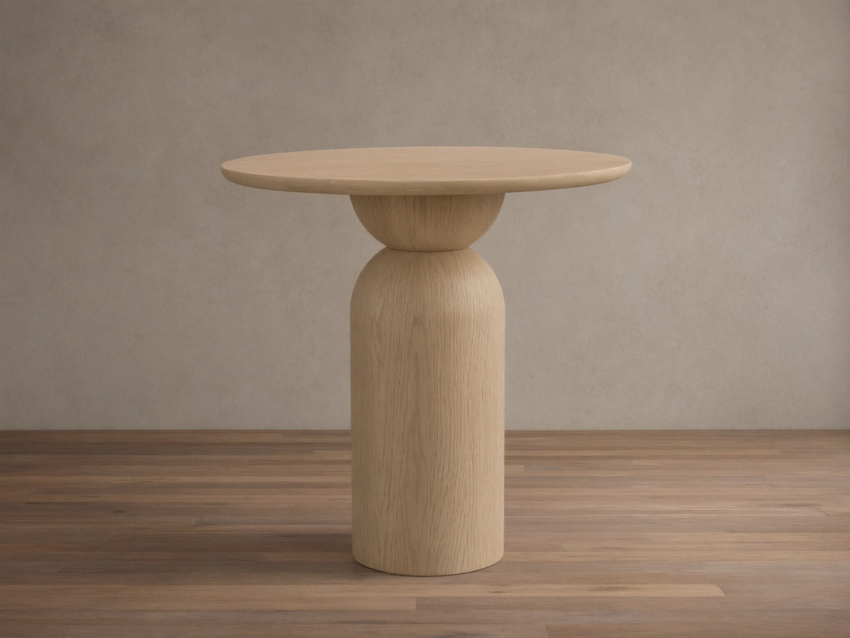 Front view of the light natural wood Perth Bistro Table with a round top and a sculptural pedestal base.