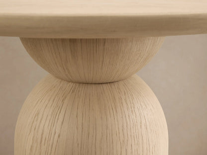 Front view of the light natural wood Perth Bistro Table with a round top and a sculptural pedestal base.