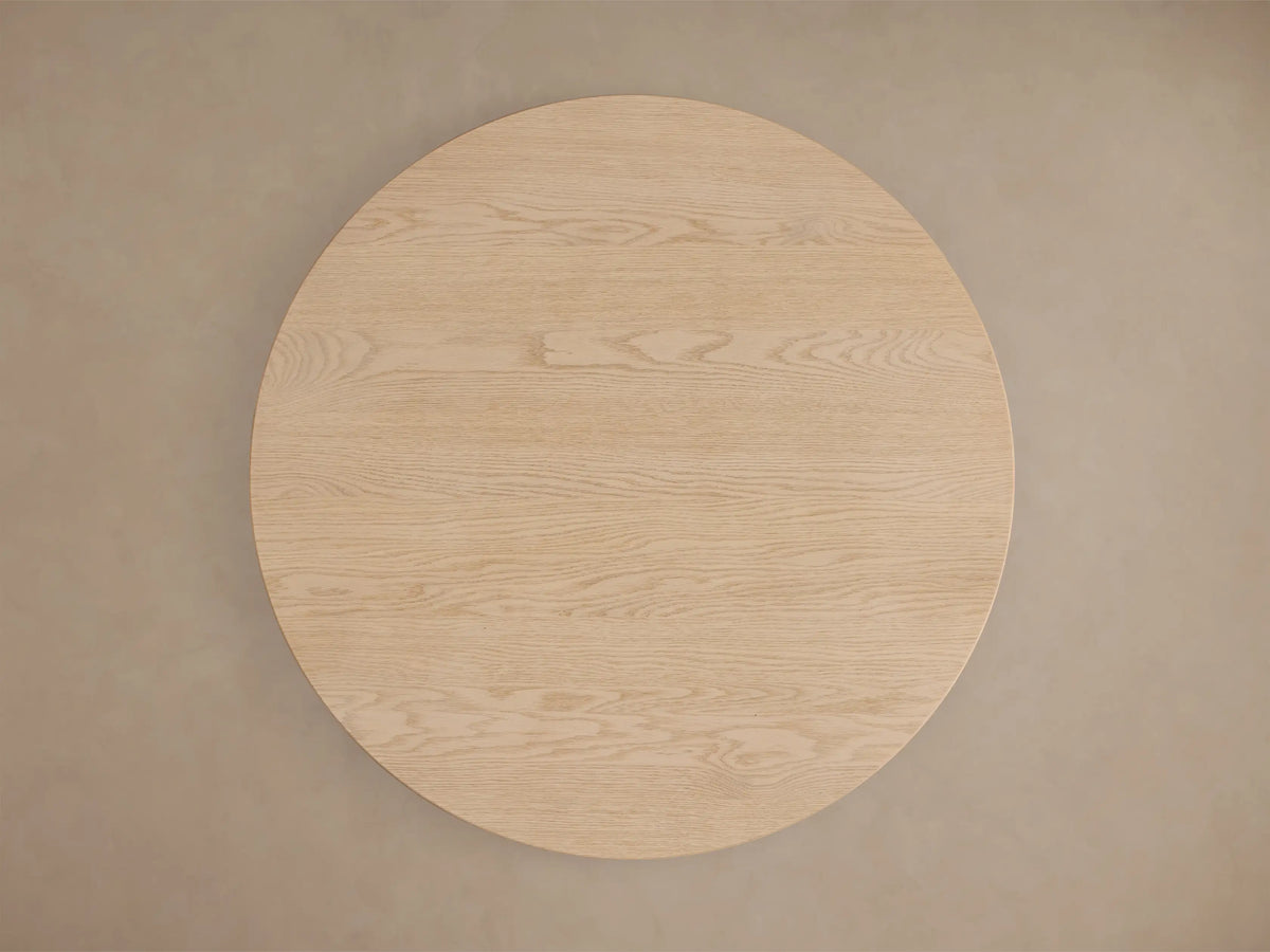 Close-up of the light natural wood Perth Bistro Table base, highlighting the vertical grain and two stacked rounded forms.