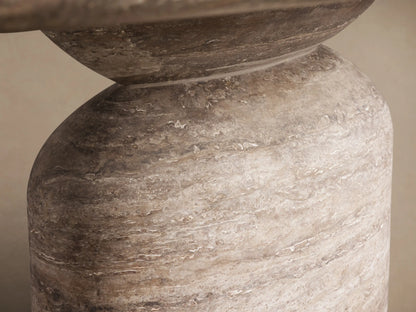Front view of the oval Perth Oval Stone Dining Table with a natural travertine top and a round, textured pedestal base.