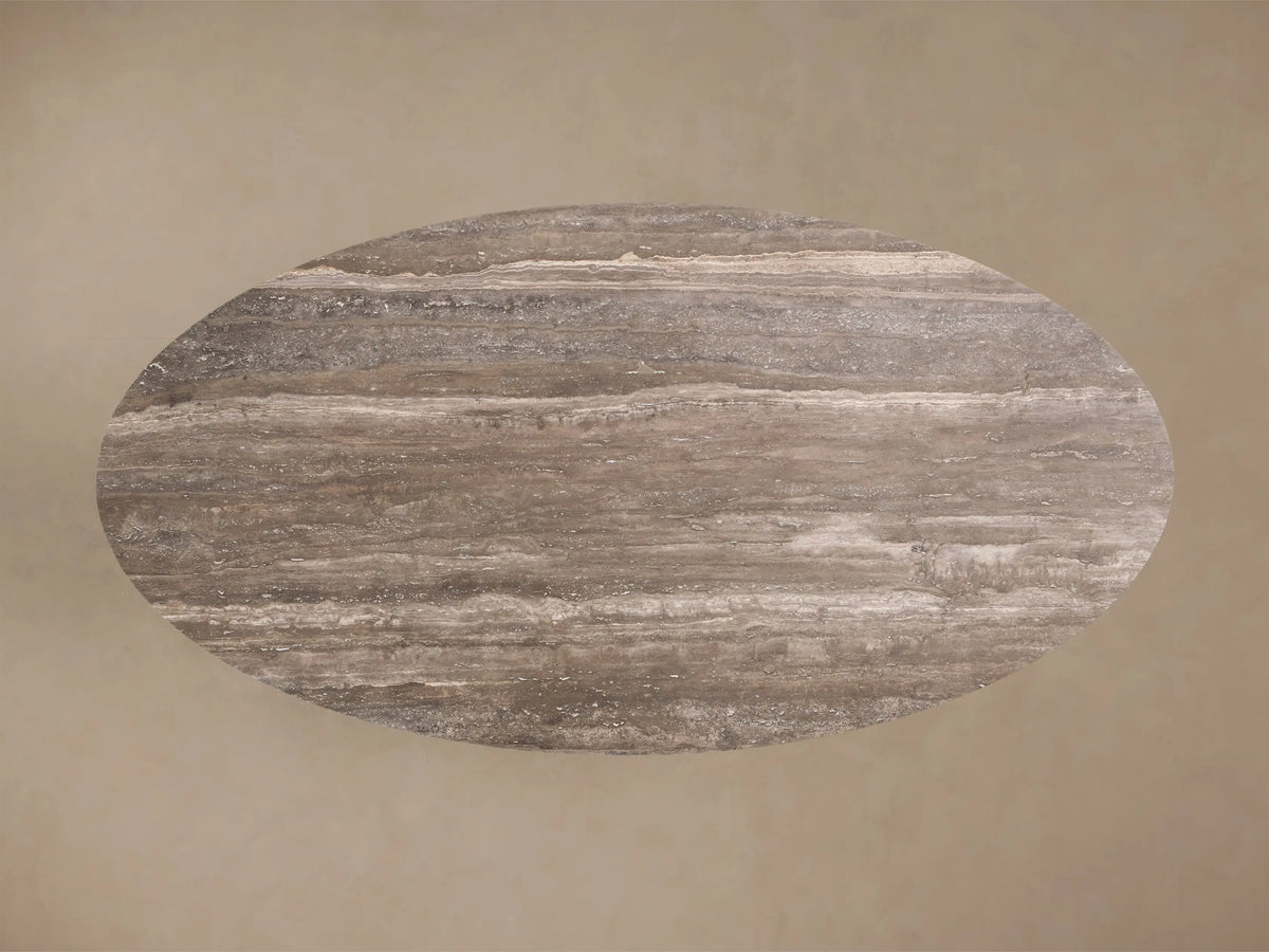 Close-up of the Perth Oval Stone Dining Table, showing its brown and grey natural stone tabletop with cream veining and smooth edge.