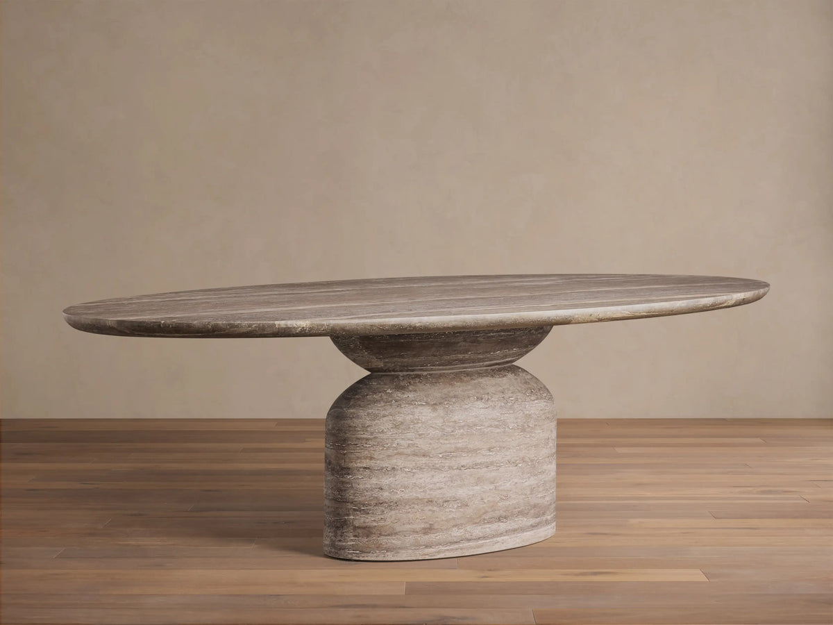 Top-down view of the Perth Oval Stone Dining Table, showing its oval gray-brown travertine surface with horizontal veining.