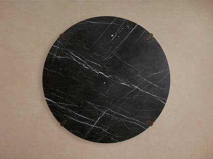 Round dining table with a black marble top featuring white veining, supported by solid red oak legs with a dark finish.