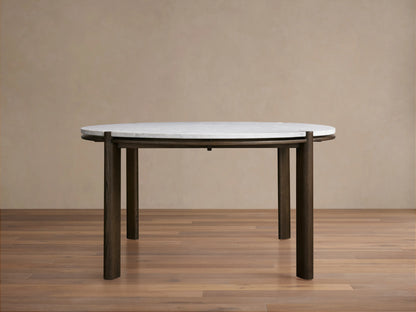 Round dining table with white Carrara marble top featuring gray veining, supported by solid red oak wood bases, seen from above.