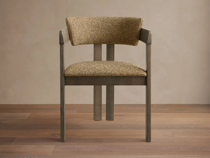 Front view of a Rodin Dining Arm Chair with a light ash wood frame and a textured, woven tan upholstered seat and back.