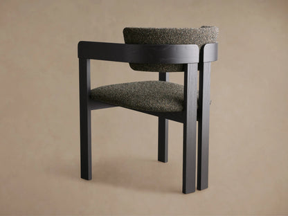 Front view of the Rodin Dining Arm Chair with a dark finished ash wood frame and speckled dark gray upholstered seat and backrest.