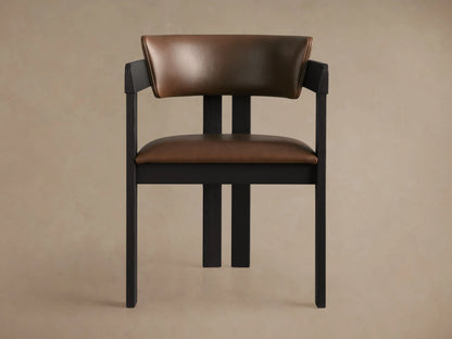 Rodin Faux Leather Arm Chair: angled view of dark ash wood frame with brown faux leather seat and curved back, on wood floor.