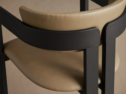 Front view of a Rodin Faux Leather Arm Chair with a dark ash wood frame and tan faux leather seat and back.