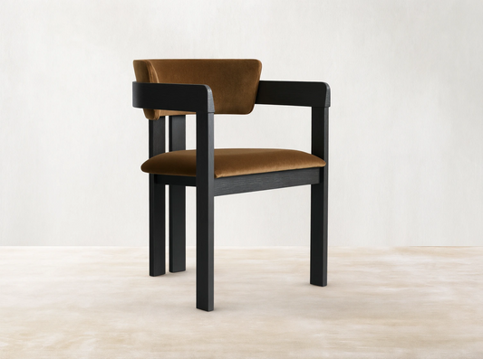 Rodin Dining Arm Chair made of ash wood with a dark frame and light brown cushioned seat and backrest, on a wooden floor.