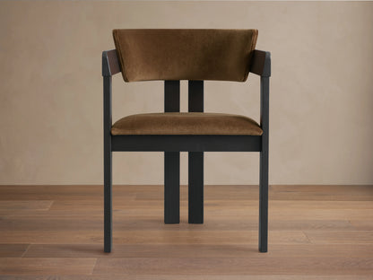 Rodin Dining Arm Chair made of ash wood with a dark frame and light brown cushioned seat and backrest, on a wooden floor.