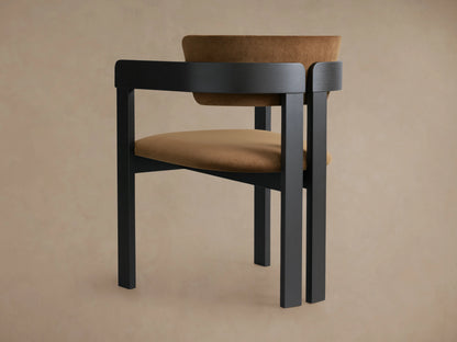 Rodin Dining Arm Chair in close-up, showing its curved ash wood frame with a dark finish and a soft tan fabric backrest.