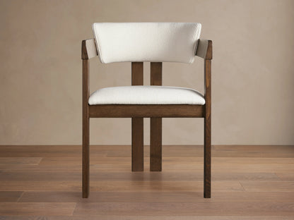 Rodin Dining Arm Chair made of dark ash wood with a white cushioned seat and backrest, displayed on a wooden floor.