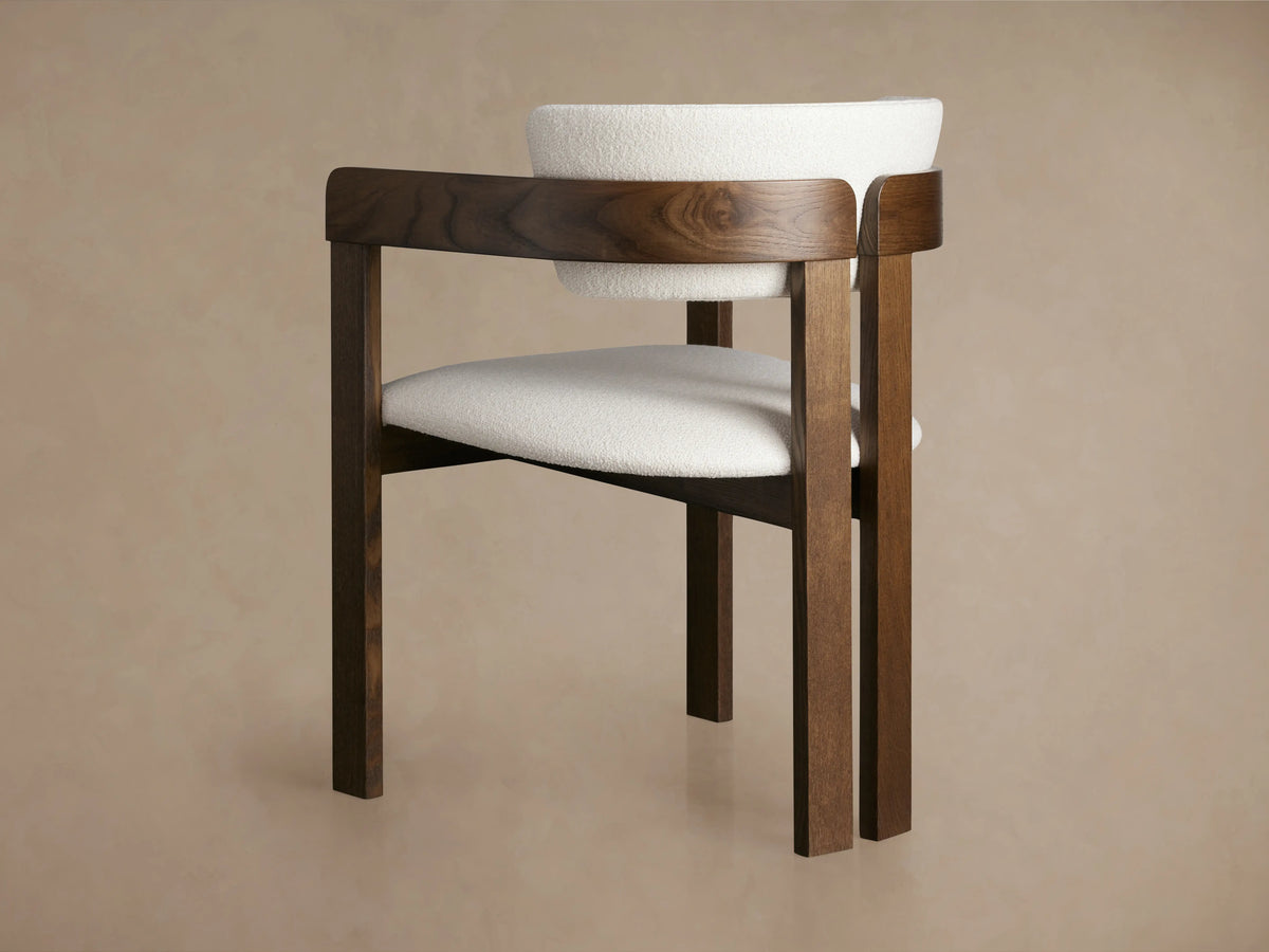 Rodin Dining Arm Chair in ash wood with a curved backrest. Features white cushioned upholstery and rich wood finishes.