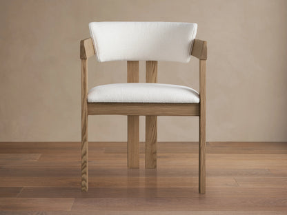 Rodin Dining Arm Chair in Natural featuring ash wood frame, curved backrest, and cushioned seat in white fabric, side view.