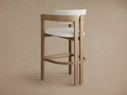 Rodin Barstool in Natural, featuring a round seat upholstered in textured cream fabric, surrounded by natural ash wood backrest and legs.