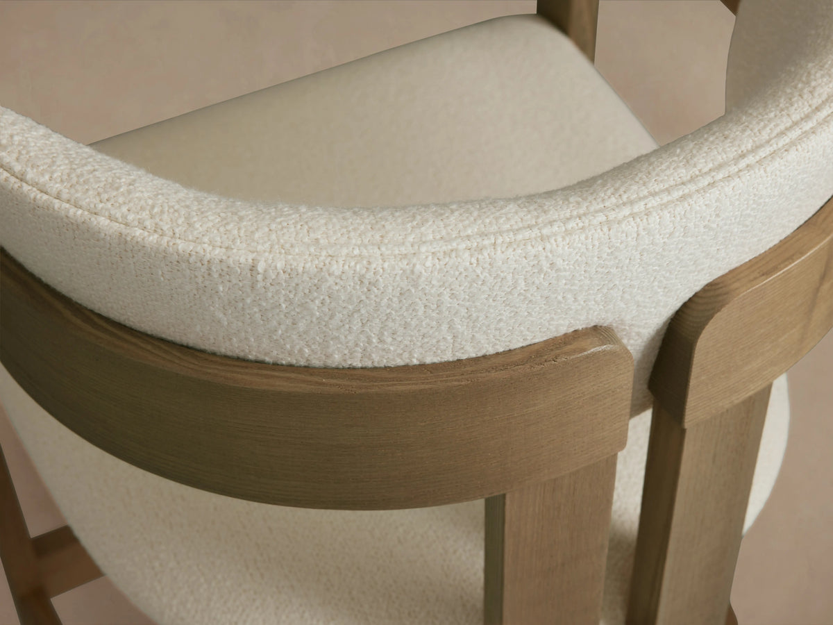 Natural ash wood Rodin Counter Stool with a light upholstered seat and backrest, featuring a sturdy wooden frame with side supports.