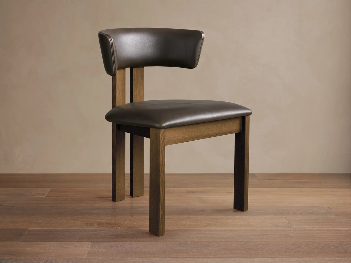 Dark brown faux leather Rodin Dining Side Chair with a padded seat, curved back, and a natural medium brown ash wood frame.