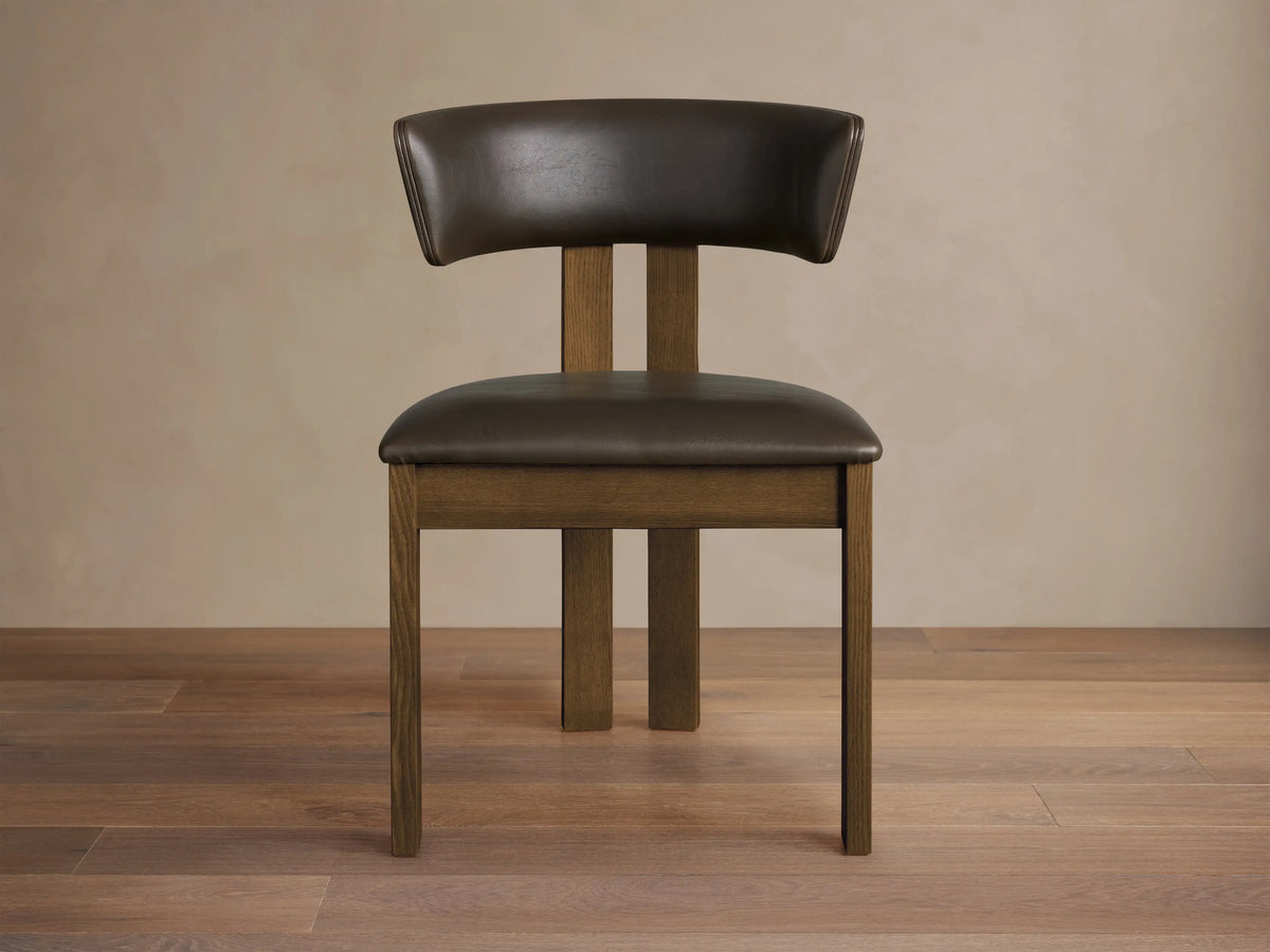 Dark brown faux leather Rodin Dining Side Chair with a padded seat, curved back, and a natural medium brown ash wood frame.