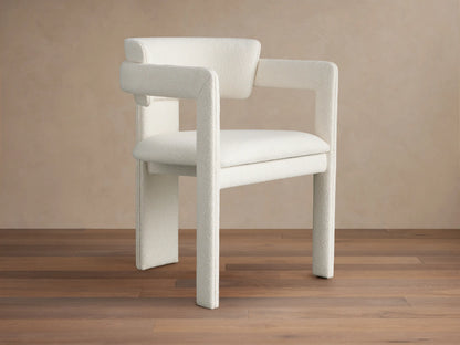 Front view of the Matera Cashmere Rodin Upholstered Dining Arm Chair with broad, curved armrests and textured fabric.