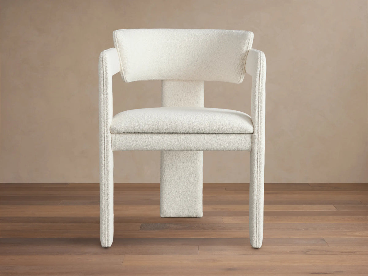 Front view of the Matera Cashmere Rodin Upholstered Dining Arm Chair with broad, curved armrests and textured fabric.