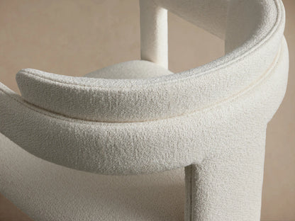 Front view of the Matera Cashmere Rodin Upholstered Dining Arm Chair, featuring armrests and a distinctive block-style back.