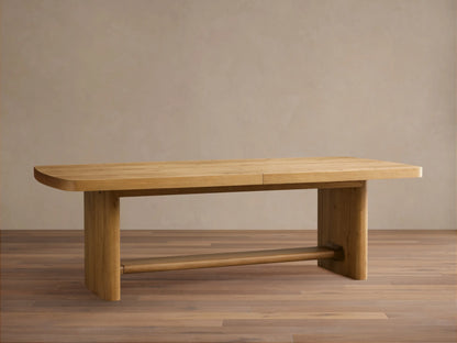 Close-up of a light oak Redding Extension Dining Table, partially open to reveal its self-storing leaf mechanism. Natural wood grain.