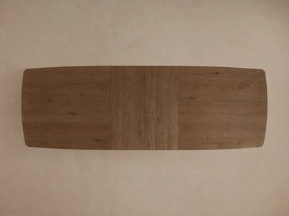 Front view of a dark brown wooden dining table with rounded corners, a central seam, and thick block legs connected by a stretcher.