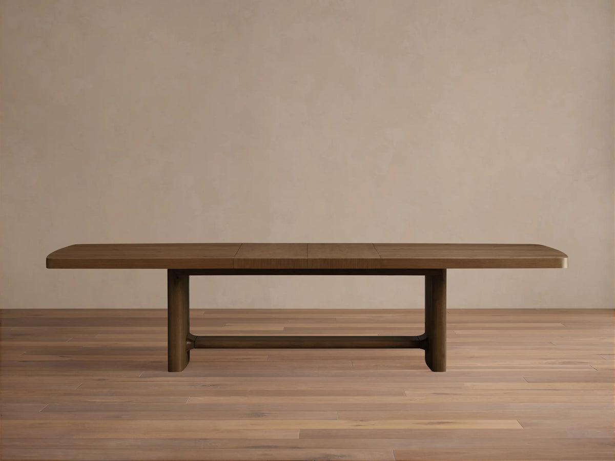 Top-down view of the natural wood finish extendable wooden dining table with rounded corners.
