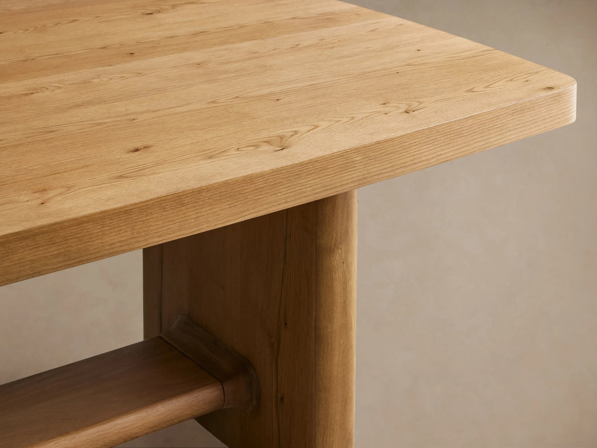 Light oak Redding Extension Dining Table, rectangular with rounded corners, visible center seam, sturdy legs on a wood floor.