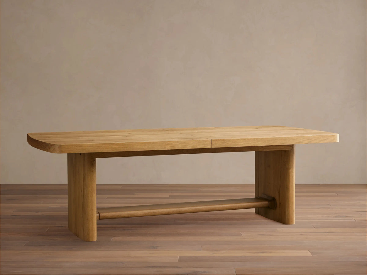 Redding Extension Dining Table in natural oak, partially extended, revealing a self-storing leaf and metal extension mechanism.