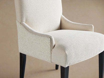 Rhen Dining Chair with tall backrest, upholstered in off-white Crypton® fabric, features dark wooden legs on a wooden floor.