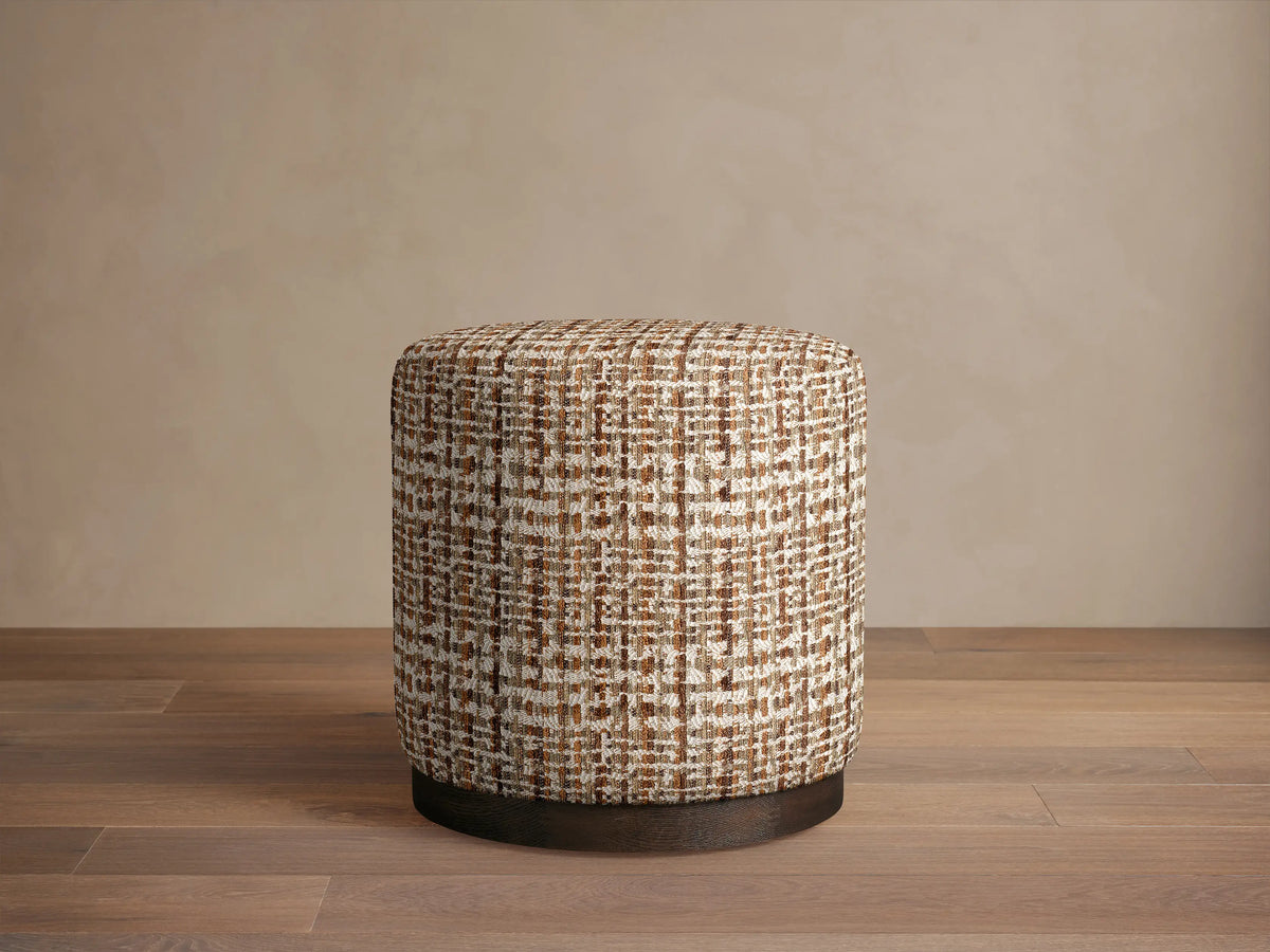 Roe Dining Stool: round, upholstered in brown, cream, white textured plaid fabric, with a dark mocha wire-brushed oak base.