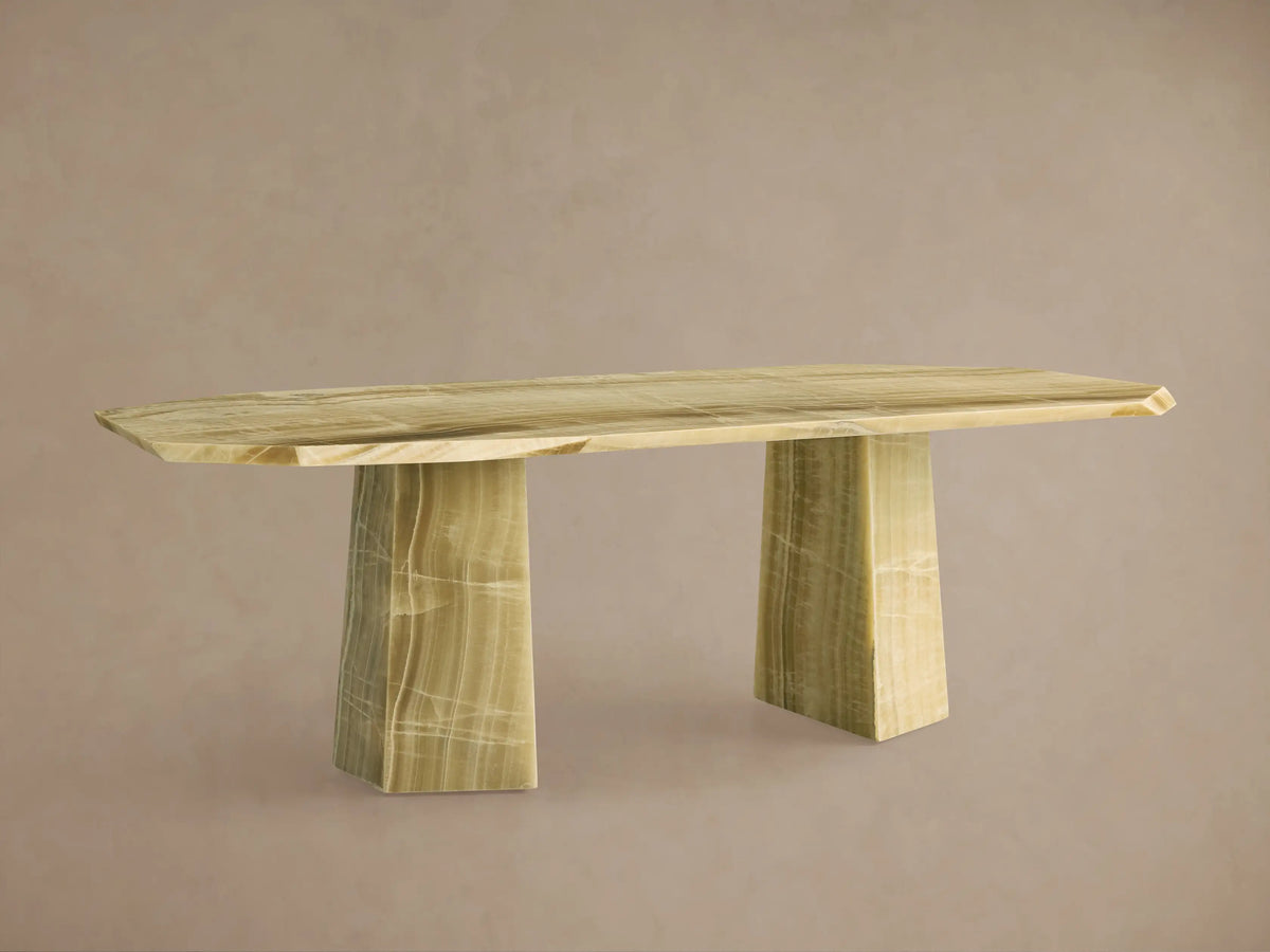 Full view of the light green onyx Zyra Stone Dining Table with an octagonal top, chiseled edges, and two solid pedestal bases.
