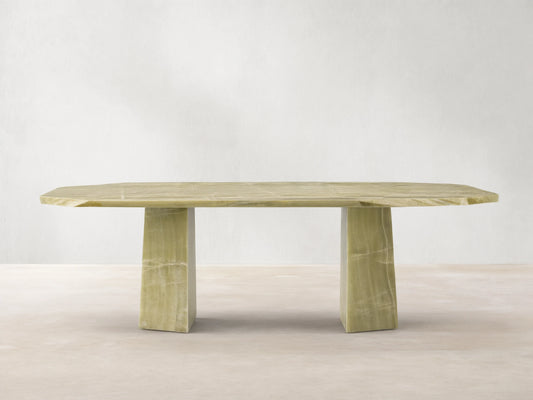 Zyra Stone Dining Table. Solid green onyx table with a rectangular top and organic edges on two thick pedestal bases.