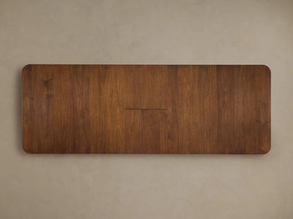 Ross Extension Dining Table with a self-storing leaf extended. Made of rich walnut wood with visible grain patterns and sleek, modern design.