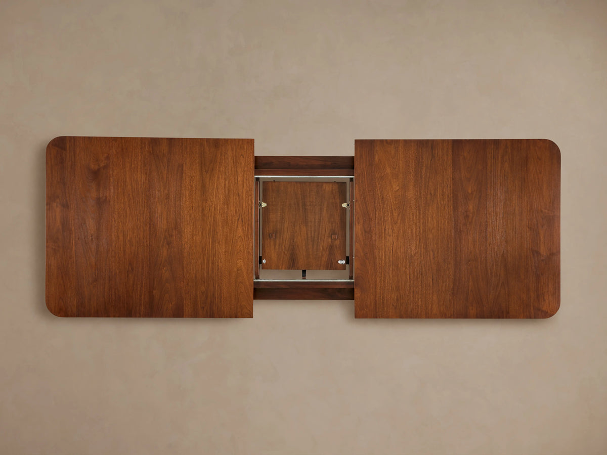 Ross Extension Dining Table made from solid walnut wood with a rich brown finish, rectangular shape, rounded corners, viewed from above.