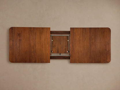 Ross Extension Dining Table made from solid walnut wood with a rich brown finish, rectangular shape, rounded corners, viewed from above.