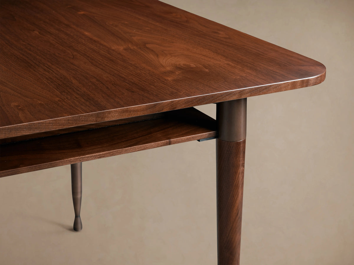 Ross Extension Dining Table in solid walnut with mid-century design, patina brass leg caps, and floating shelf detail on tabletop.