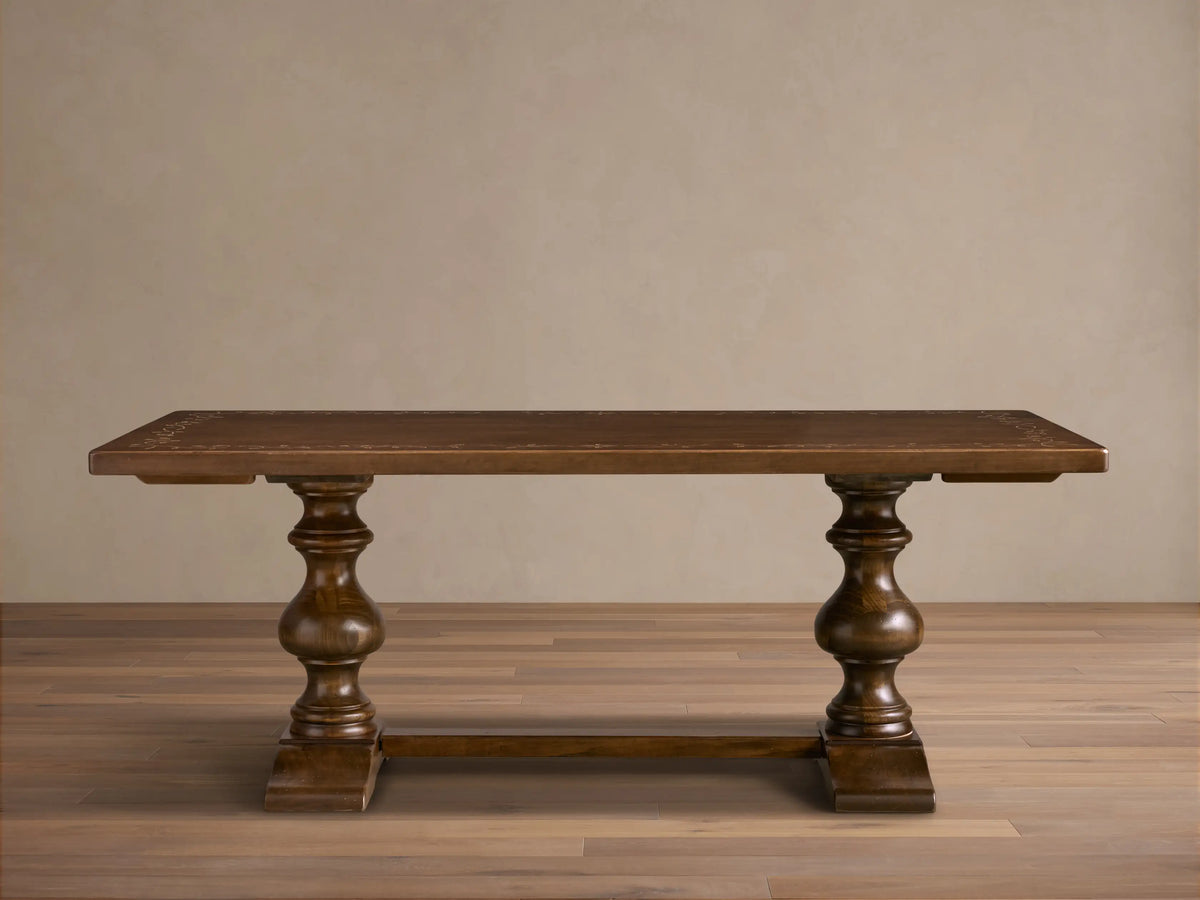 Top-down view of the dark brown wood Stefania Oval Extension Dining Table with light botanical leafy motifs.