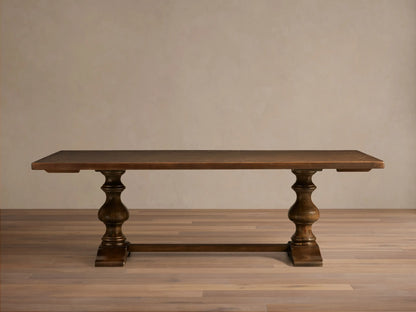 Front view of the dark wood Stefania Oval Extension Dining Table with two hand-turned pedestal legs and an oval top.