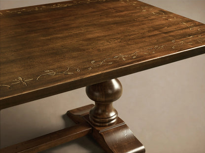 Front view of the dark brown Stefania Oval Extension Dining Table, featuring hand-turned pedestal legs and a subtle hand-painted decor.
