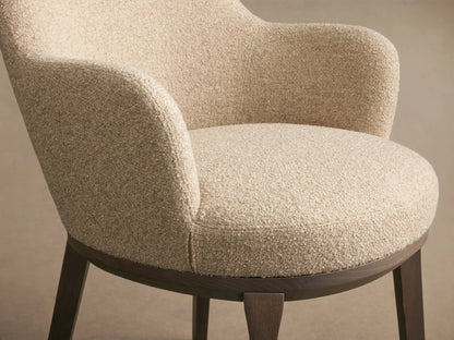 Front view of a light beige textured Simone Dining Arm Chair with dark wood legs and base.