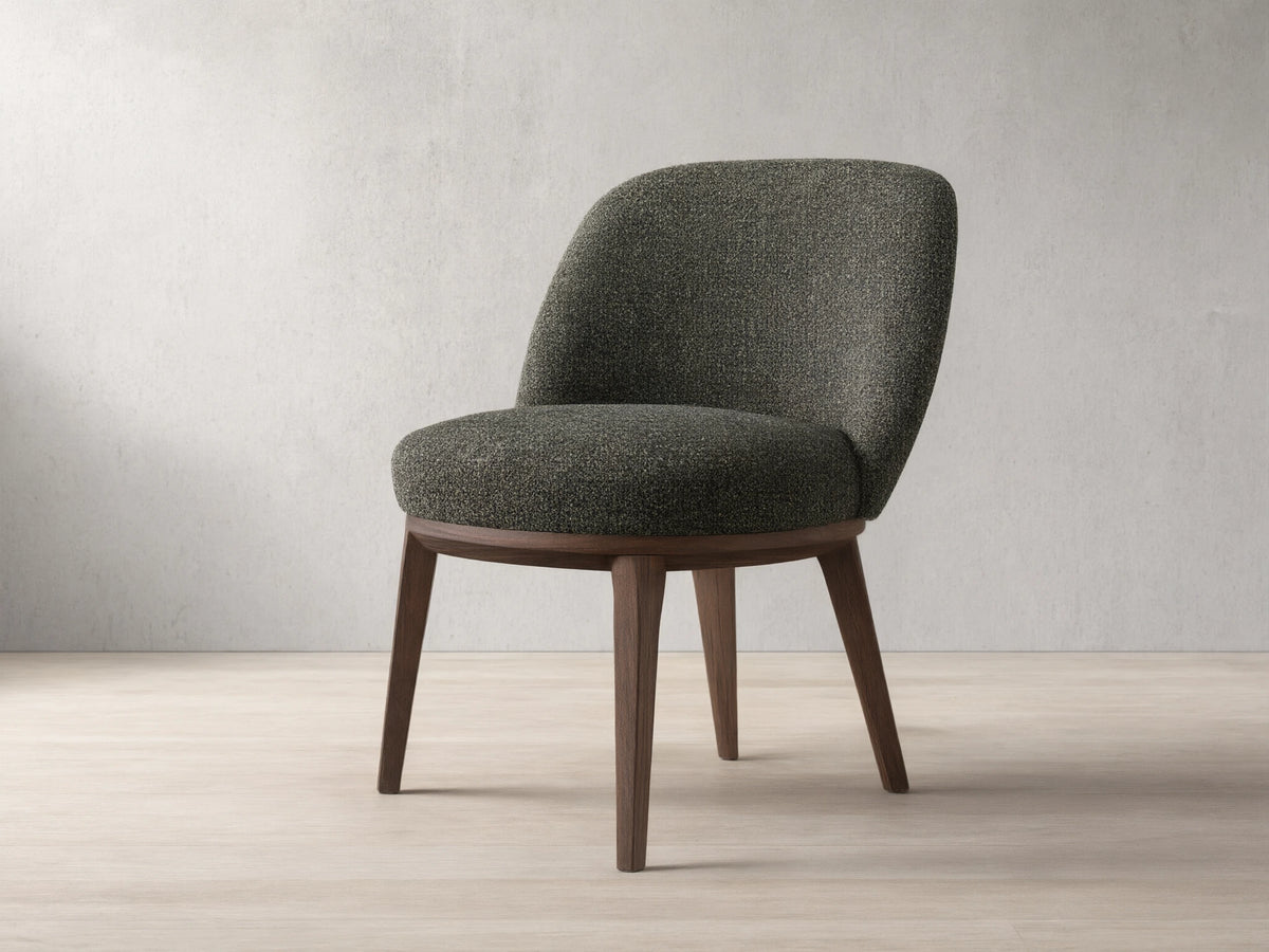 Front view of a dark speckled upholstered Simone Dining Side Chair with dark wood legs and a curved back.