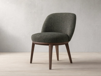Front view of a dark speckled upholstered Simone Dining Side Chair with dark wood legs and a curved back.