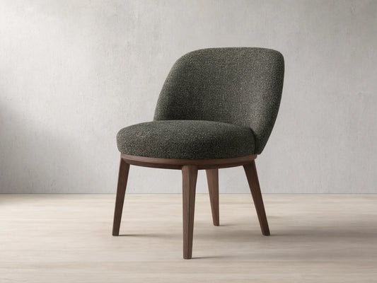 Front view of a dark speckled upholstered Simone Dining Side Chair with dark wood legs and a curved back.