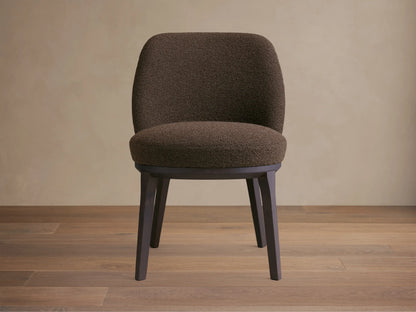 Simone Dining Side Chair in a dark brown textured fabric, featuring a curved backrest and cushioned seat with dark wooden legs.