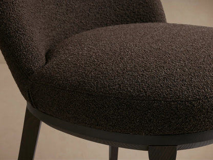 Brown Simone Dining Side Chair with upholstered backrest and seat, solid dark ash wood frame, displayed on wooden floor, beige background.