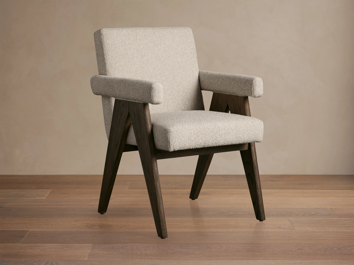 Stanley Dining Arm Chair in Mocha with oak wood frame and ecru fabric, angled view on wooden floor.