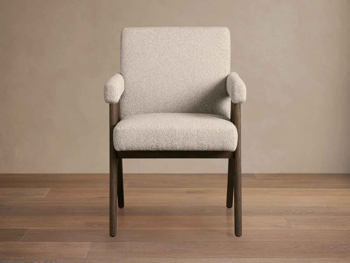 Stanley Dining Arm Chair in Mocha with oak wood frame and ecru fabric, angled view on wooden floor.